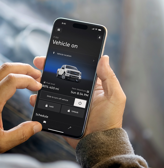 Hand holding phone with the Ford app