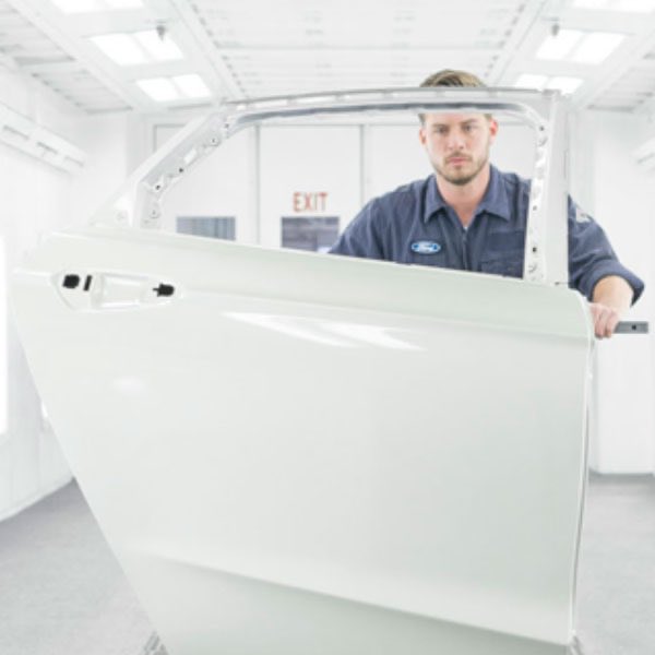Body technician with a vehicle door panel